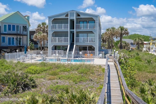 2900 Coastal Hwy # 1, Saint Augustine, FL 32084 - back of house featuring fence, a community pool, and a balcony