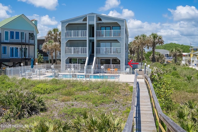 2900 Coastal Hwy # 1, Saint Augustine, FL 32084 - back of property with a community pool, a patio area, and fence