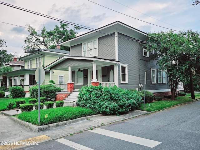 american foursquare style home featuring a porch