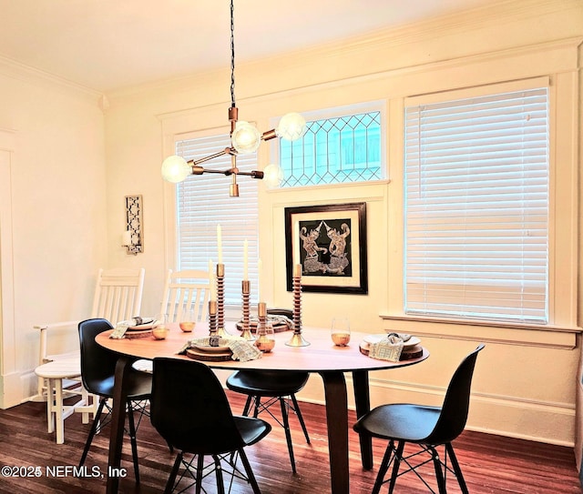 dining area with an inviting chandelier, baseboards, ornamental molding, and dark wood-type flooring