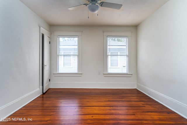 spare room with a ceiling fan, baseboards, and wood finished floors