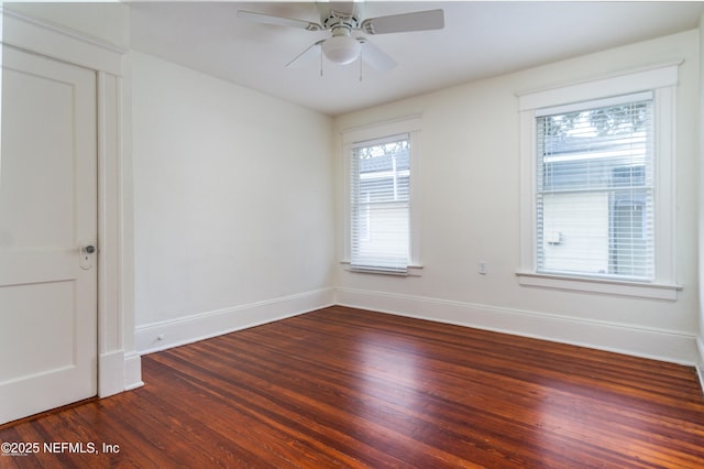 empty room featuring baseboards, a ceiling fan, and wood finished floors