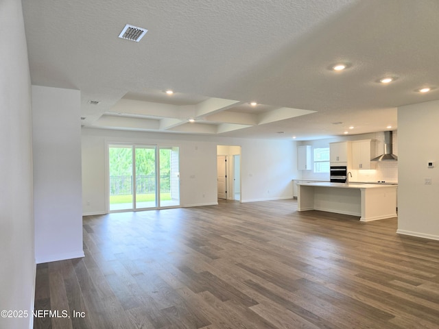 3267 Pipers Way, Green Cove Springs, FL 32043 - unfurnished living room featuring dark wood-style floors, baseboards, recessed lighting, a sink, and a textured ceiling