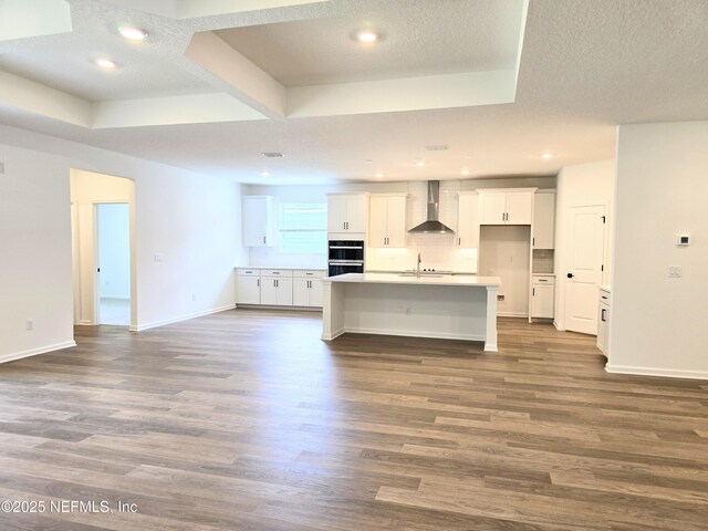 3267 Pipers Way, Green Cove Springs, FL 32043 - kitchen with wall chimney exhaust hood, dark wood-style floors, white cabinets, stainless steel double oven, and recessed lighting