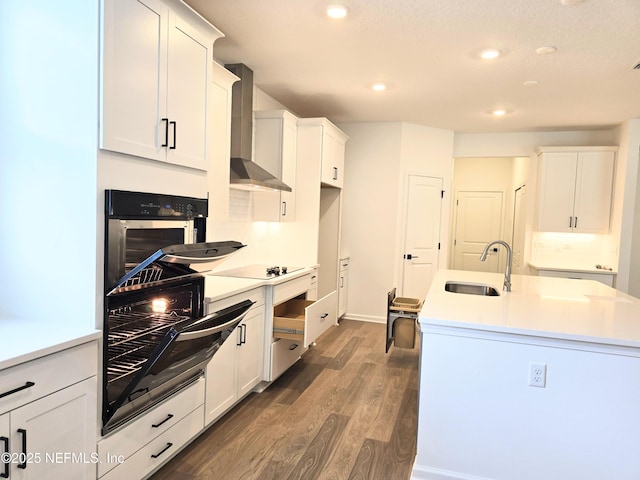 3267 Pipers Way, Green Cove Springs, FL 32043 - kitchen with a sink, stainless steel oven, wall chimney range hood, dark wood-style flooring, and white cabinetry