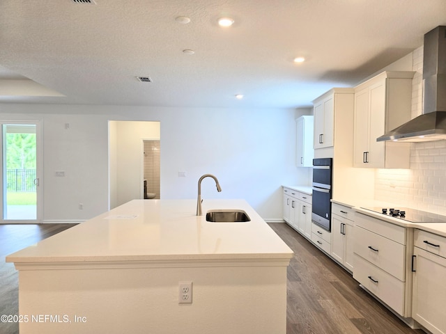 3267 Pipers Way, Green Cove Springs, FL 32043 - kitchen featuring a sink, wall chimney exhaust hood, dark wood-style flooring, an island with sink, and recessed lighting