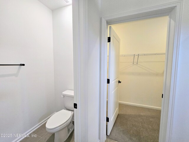 3267 Pipers Way, Green Cove Springs, FL 32043 - bathroom with baseboards, toilet, and a walk in closet
