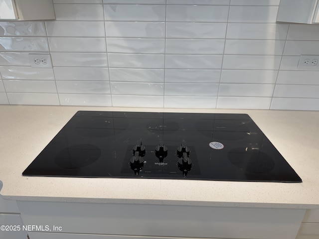 2672 Charmer Ct, Green Cove Springs, FL 32043 - room details featuring light stone countertops, backsplash, and black electric cooktop