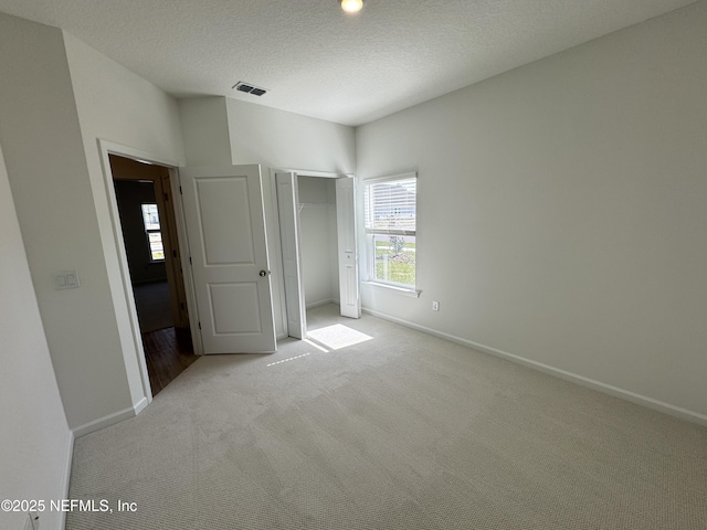 2672 Charmer Ct, Green Cove Springs, FL 32043 - unfurnished bedroom with visible vents, a closet, light carpet, baseboards, and a textured ceiling