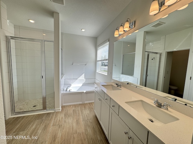 2672 Charmer Ct, Green Cove Springs, FL 32043 - full bath with wood finished floors, a sink, a bath, and a stall shower
