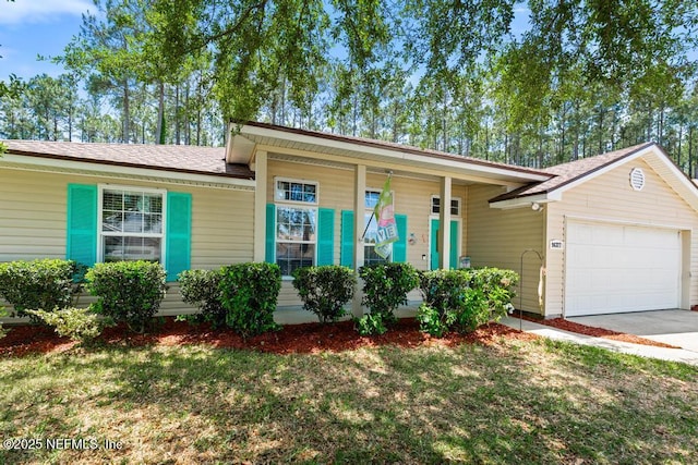 ranch-style home featuring an attached garage, driveway, and a front lawn
