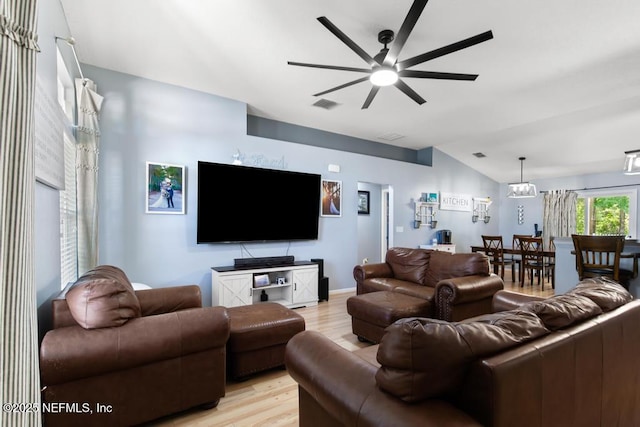 living room with ceiling fan, lofted ceiling, light wood finished floors, and visible vents