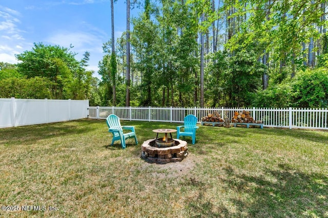 view of yard with a fenced backyard and an outdoor fire pit