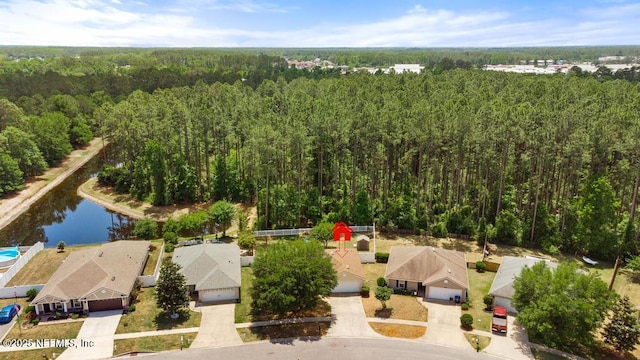 birds eye view of property with a residential view, a view of trees, and a water view