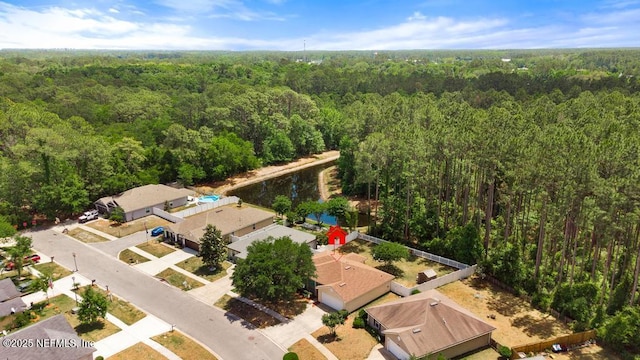 drone / aerial view featuring a wooded view