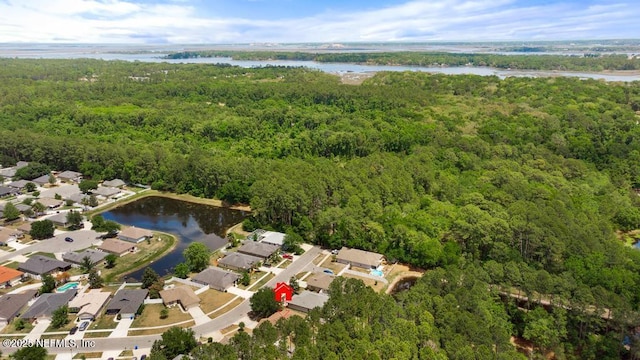 aerial view featuring a water view, a view of trees, and a residential view
