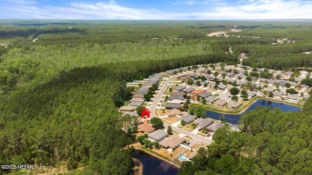 bird's eye view featuring a water view, a view of trees, and a residential view