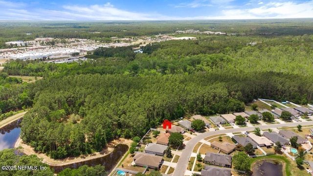 aerial view featuring a water view and a forest view