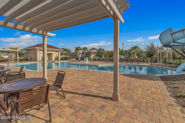 4323 Warm Springs Way, Middleburg, FL 32068 - community pool with fence, a patio area, a water slide, and a pergola