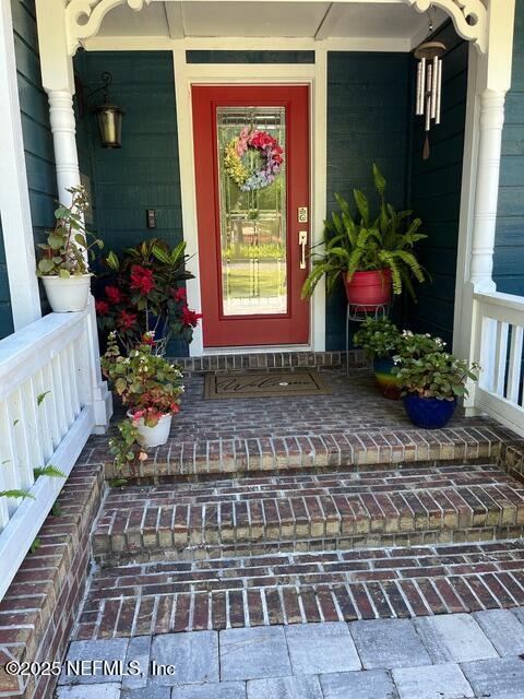 view of exterior entry featuring a porch