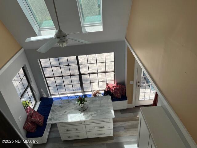 living area with ceiling fan and wood finished floors