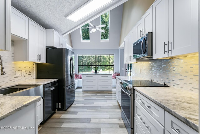 kitchen featuring electric range, dishwasher, light wood-style flooring, a ceiling fan, and white cabinetry