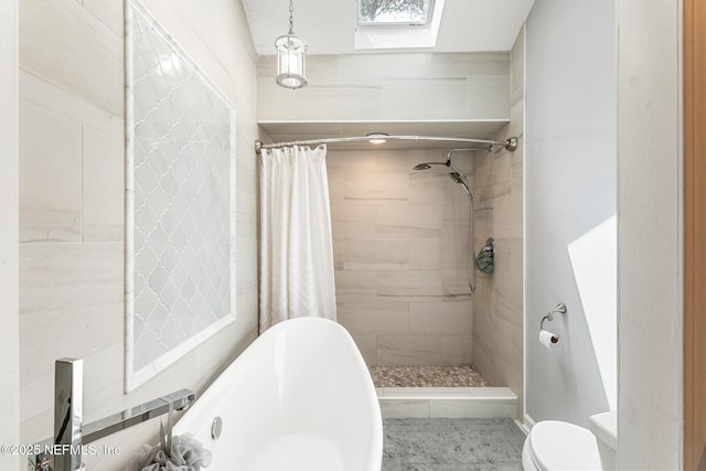 full bathroom with a skylight, a freestanding tub, a tile shower, and toilet