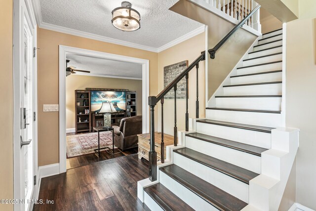 entrance foyer featuring stairs, baseboards, a textured ceiling, and wood finished floors