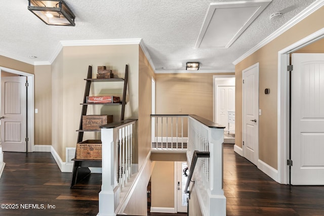 hall featuring a textured ceiling, dark wood finished floors, and an upstairs landing
