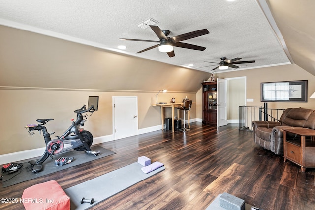 exercise room featuring a textured ceiling, ceiling fan, vaulted ceiling, and wood finished floors