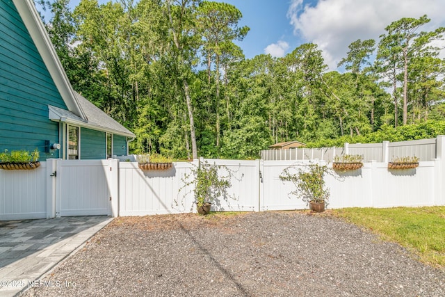 view of patio featuring fence and a gate