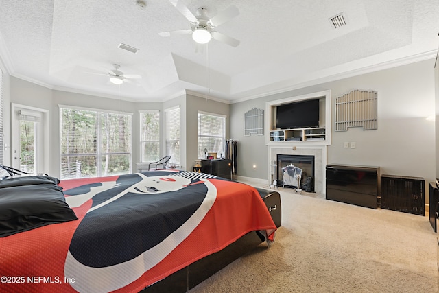 1304 Hideaway Dr S, Saint Johns, FL 32259 - carpeted bedroom with a raised ceiling, ornamental molding, a tile fireplace, a ceiling fan, and a textured ceiling