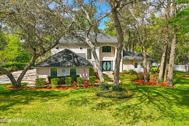 1304 Hideaway Dr S, Saint Johns, FL 32259 - mediterranean / spanish-style home featuring stucco siding, a front lawn, concrete driveway, and a shingled roof