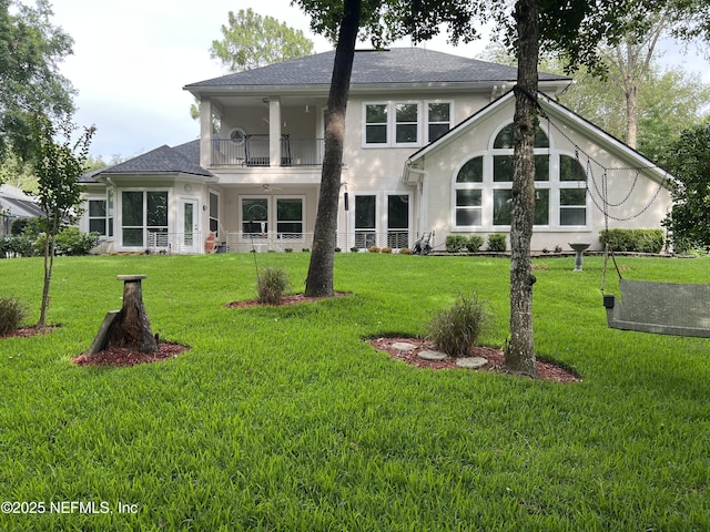1304 Hideaway Dr S, Saint Johns, FL 32259 - back of house with a balcony, stucco siding, a lawn, and a shingled roof