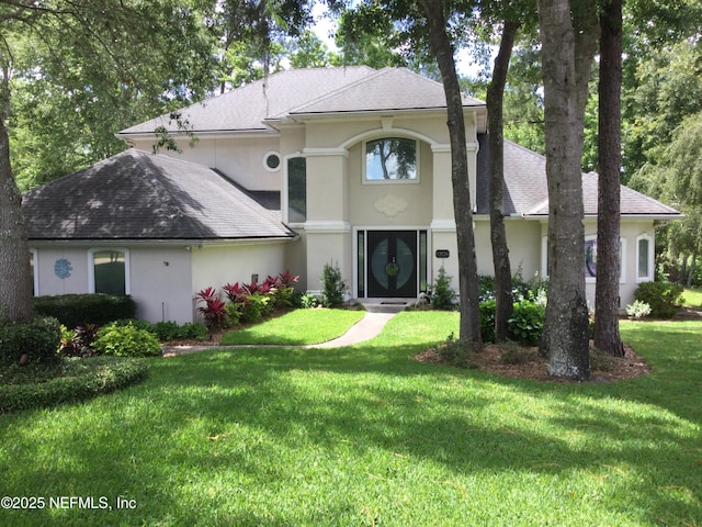 1304 Hideaway Dr S, Saint Johns, FL 32259 - view of front facade with stucco siding, a front yard, and a shingled roof