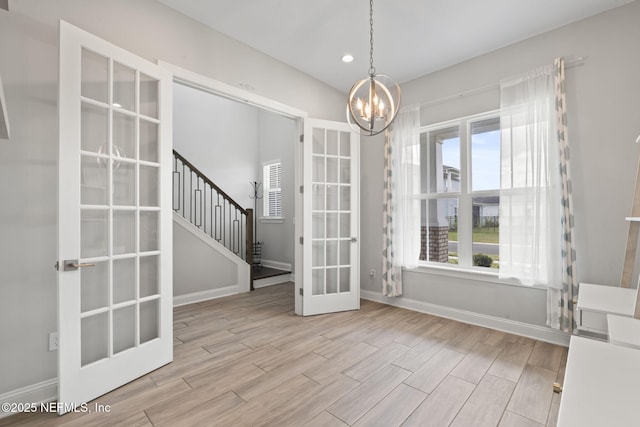 201 Bridgeton St, Saint Johns, FL 32259 - spare room featuring a notable chandelier, french doors, baseboards, wood finished floors, and stairway