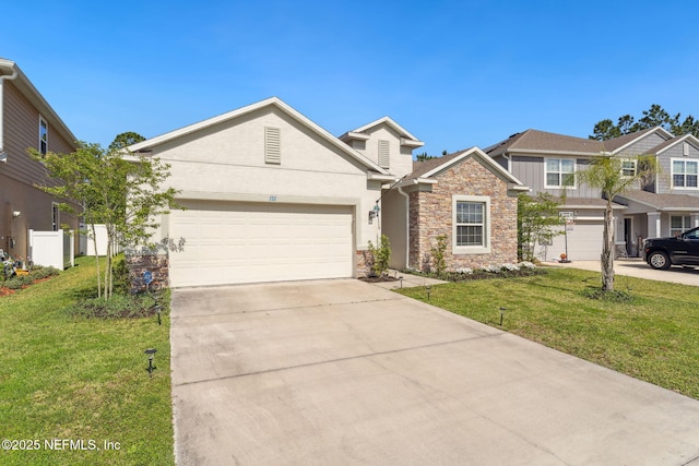 120 Oakleaf Way, Palm Coast, FL 32137 - view of front facade featuring concrete driveway, a front yard, an attached garage, and stone siding