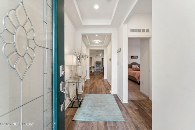 120 Oakleaf Way, Palm Coast, FL 32137 - entrance foyer featuring visible vents, baseboards, a raised ceiling, and wood finished floors