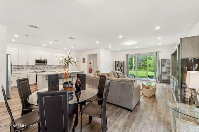 120 Oakleaf Way, Palm Coast, FL 32137 - dining room featuring visible vents, recessed lighting, and light wood finished floors