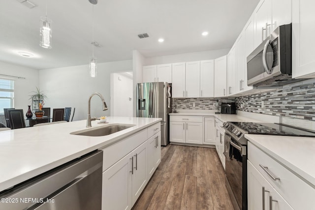 120 Oakleaf Way, Palm Coast, FL 32137 - kitchen featuring visible vents, light countertops, tasteful backsplash, a sink, and stainless steel appliances