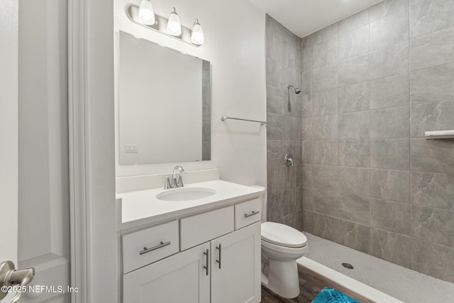 120 Oakleaf Way, Palm Coast, FL 32137 - full bath with toilet, a tile shower, wood finished floors, and vanity