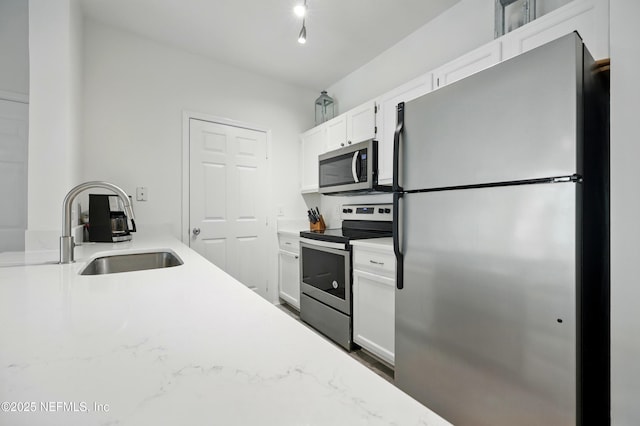 150 Veracruz Dr Unit 537, Ponte Vedra Beach, FL 32082 - kitchen with a sink, stainless steel appliances, light stone countertops, and white cabinets