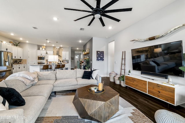 living area with dark wood-style floors, ceiling fan, and recessed lighting
