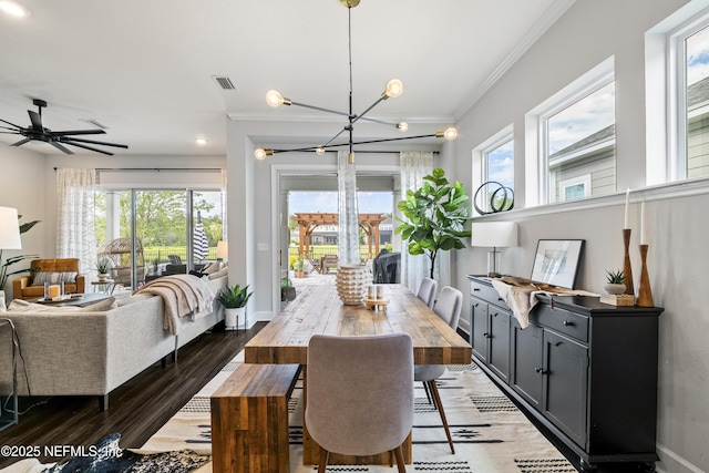 dining space with crown molding, healthy amount of natural light, a chandelier, baseboards, and light wood-style floors