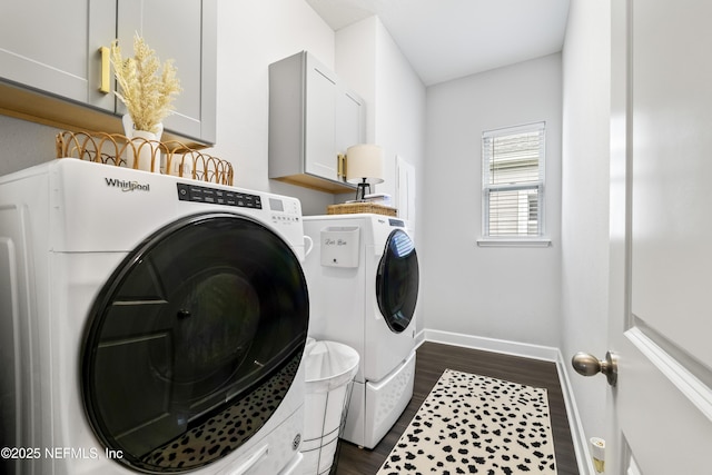laundry room with separate washer and dryer, cabinet space, dark wood-style floors, and baseboards