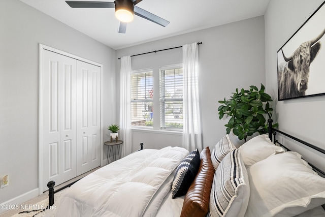 bedroom featuring a closet, carpet, baseboards, and a ceiling fan