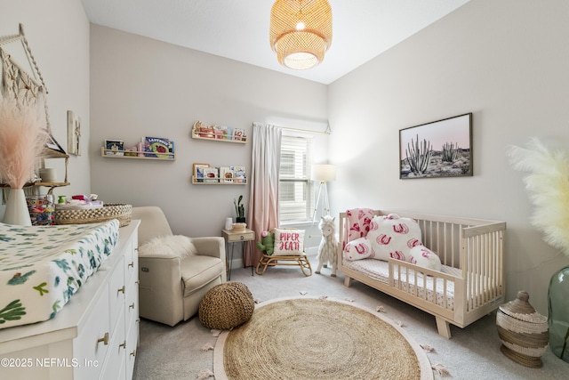 bedroom featuring light colored carpet and a crib