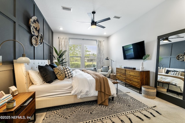 bedroom with ceiling fan and light colored carpet