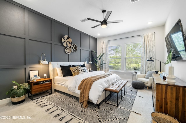 bedroom featuring a decorative wall, carpet, a ceiling fan, baseboards, and recessed lighting