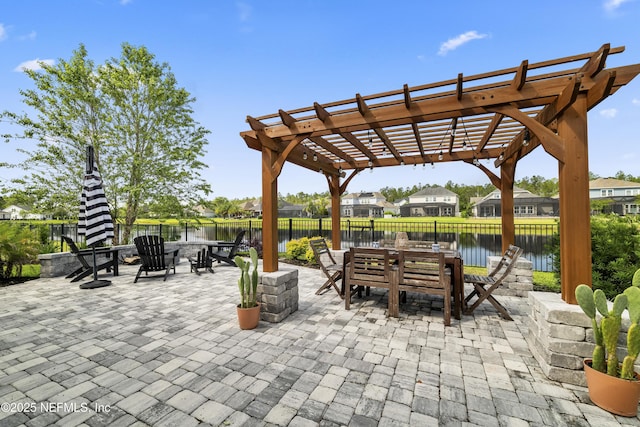 view of patio featuring outdoor dining space, a pergola, a fenced backyard, and a water view